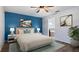 Bedroom with blue accent wall and en-suite bathroom access at 155 Kissengen Park Blvd, Bartow, FL 33830