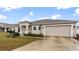 House exterior showcasing a beige facade and spacious driveway at 155 Kissengen Park Blvd, Bartow, FL 33830