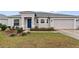 Front view of a house with a blue door and attached garage at 155 Kissengen Park Blvd, Bartow, FL 33830