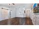 Open living room featuring wood-look floors, barn door, and accent wall at 155 Kissengen Park Blvd, Bartow, FL 33830