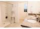 Bathroom with double vanity, shower, and linen closet at 1726 Eagle Hammock Blvd, Eagle Lake, FL 33839