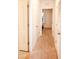 Bright hallway with carpet and neutral-toned doors leading to bedrooms at 1726 Eagle Hammock Blvd, Eagle Lake, FL 33839