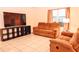 Living room featuring brown reclining sofas and a large TV at 1726 Eagle Hammock Blvd, Eagle Lake, FL 33839