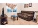 Living area with brown sectional sofa and cat tree at 1726 Eagle Hammock Blvd, Eagle Lake, FL 33839