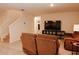 Relaxing living room with brown reclining sofas and large TV at 1726 Eagle Hammock Blvd, Eagle Lake, FL 33839