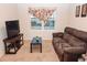 Relaxing living room featuring a brown couch and window at 1726 Eagle Hammock Blvd, Eagle Lake, FL 33839