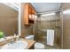 Clean bathroom with shower, toilet and wood cabinets at 1801 Quail Hill Dr, Lakeland, FL 33810