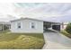 Well-maintained manufactured home with carport and landscaped lawn at 1801 Quail Hill Dr, Lakeland, FL 33810