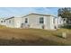 Tan home exterior with landscaping and storage shed at 1801 Quail Hill Dr, Lakeland, FL 33810