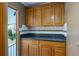 Dark-countertop kitchen with wood cabinets and tiled backsplash at 1801 Quail Hill Dr, Lakeland, FL 33810