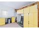 Laundry room with yellow cabinets, washer, dryer, and granite countertop at 1801 Quail Hill Dr, Lakeland, FL 33810