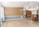 Bright living room with wood-look floors and a view into the kitchen at 1801 Quail Hill Dr, Lakeland, FL 33810