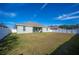 House backyard view, green lawn, fence at 1836 James Towne Ln, Bartow, FL 33830