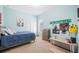 Comfortable bedroom with light blue walls, a work desk, posters, and carpet at 1836 James Towne Ln, Bartow, FL 33830