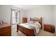 Cozy bedroom with a wooden bed frame, side tables, and window at 1836 James Towne Ln, Bartow, FL 33830