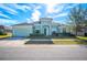 Beautiful light green house with a three-car garage and well-manicured lawn at 1836 James Towne Ln, Bartow, FL 33830