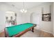 Pool table in game room, kitchen view at 1836 James Towne Ln, Bartow, FL 33830