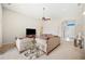 Inviting living room featuring high ceilings, a ceiling fan, and plush seating at 1836 James Towne Ln, Bartow, FL 33830