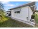 Corner of home shows white siding, green lawn, rock landscaping and corner awnings at 1847 Masters Ln, Lakeland, FL 33810