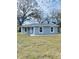 Newly constructed home with gray siding and a well-manicured lawn at 2006 Kendrick Ln, Lakeland, FL 33805