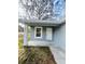 Charming front porch with white door and gray siding at 2006 Kendrick Ln, Lakeland, FL 33805