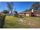 Large backyard, featuring playset and grass at 2070 Katie Ct, Winter Haven, FL 33884