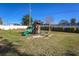 Large backyard with playset and grassy area at 2070 Katie Ct, Winter Haven, FL 33884