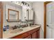 Updated bathroom with double sinks, medicine cabinets, and modern light at 2070 Katie Ct, Winter Haven, FL 33884