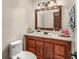 Clean bathroom with wood vanity, single sink, and updated light fixture at 2070 Katie Ct, Winter Haven, FL 33884