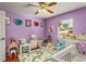 bedroom with crib, toddler bed, and playful decor at 2070 Katie Ct, Winter Haven, FL 33884