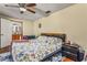 Spacious bedroom with floral bedding, ceiling fan, and hardwood floors at 2070 Katie Ct, Winter Haven, FL 33884