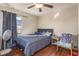 Bedroom with gray bedding, ceiling fan, and hardwood floors at 2070 Katie Ct, Winter Haven, FL 33884