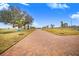 Brick driveway showcasing a country setting with mature trees at 2200 Mcclellan Rd, Frostproof, FL 33843