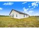 Modern farmhouse exterior with covered patio and expansive yard at 2200 Mcclellan Rd, Frostproof, FL 33843