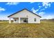 Rear view of a modern farmhouse with a covered patio at 2200 Mcclellan Rd, Frostproof, FL 33843