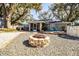 Relaxing backyard with fire pit, patio, and screened porch at 2227 Howard West Ave, Winter Haven, FL 33880