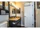 Clean bathroom with granite countertop and dark wood vanity at 2227 Howard West Ave, Winter Haven, FL 33880