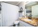 Bathroom with granite countertop, white vanity, and shower/tub combo at 2227 Howard West Ave, Winter Haven, FL 33880