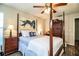 Bedroom with four-poster bed, hardwood floors and wooden cabinet at 2227 Howard West Ave, Winter Haven, FL 33880