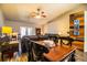 Bright dining area with wooden table and black chairs, open to living room at 2227 Howard West Ave, Winter Haven, FL 33880