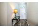 Light and airy entryway with a glass-top console table and wood flooring at 2227 Howard West Ave, Winter Haven, FL 33880