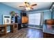 Bright home office features wood flooring, built-in shelving, and a large window at 2227 Howard West Ave, Winter Haven, FL 33880