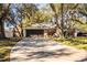 House exterior with driveway and mature trees at 2227 Howard West Ave, Winter Haven, FL 33880