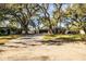 House exterior with driveway and mature trees at 2227 Howard West Ave, Winter Haven, FL 33880