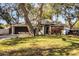 House exterior with driveway and mature trees at 2227 Howard West Ave, Winter Haven, FL 33880