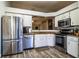 Modern kitchen with stainless steel appliances and wood-look flooring at 2227 Howard West Ave, Winter Haven, FL 33880