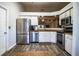 Modern kitchen with stainless steel appliances and wood-look flooring at 2227 Howard West Ave, Winter Haven, FL 33880