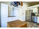 Bright kitchen with white cabinets, stainless steel appliances, and butcher block island at 2227 Howard West Ave, Winter Haven, FL 33880