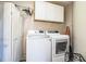 Bright laundry room with washer, dryer, and cabinets at 2227 Howard West Ave, Winter Haven, FL 33880