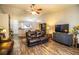 Living room with dark gray media console and leather couches at 2227 Howard West Ave, Winter Haven, FL 33880